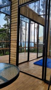 a glass door on a house with a view of a deck at Latibule Glamping in La Vega