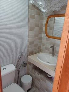 a bathroom with a toilet and a sink at casa cueva a orilla del mar Brisas del Mar in El Escobonal