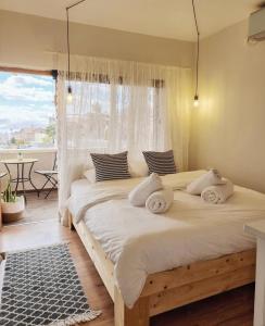 a bedroom with a large bed with white sheets at Eilat vacation house דירות נופש אילת in Eilat