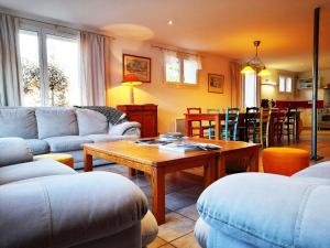 a living room with a couch and a table at ⁂⁂ GITE LES HERABLES [CLEDICIHOME] Gîte de charme // JACCUZI // SALLE DE JEUX ⁂⁂ in Granges-sur-Vologne