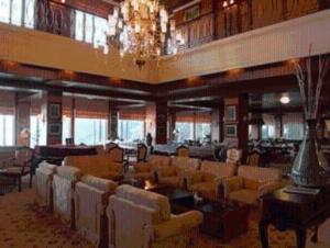 a large room with chairs and tables and a chandelier at Royal Senyiur Hotel in Prigen