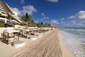 a row of tables and chairs on the beach at Paradisus Cancun All Inclusive in Cancún