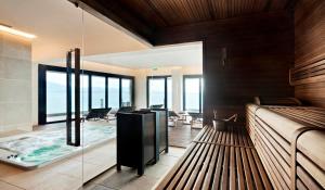 a bedroom with a bed and a view of the ocean at Grand Hotel Terme Sirmione in Sirmione