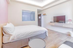 Ένα ή περισσότερα κρεβάτια σε δωμάτιο στο WOW Penghu Homestay