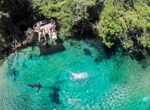 an aerial view of a person swimming in a body of water at Fazenda a 15 min do centro com Rio Particular in Bonito