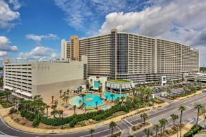 a large hotel with a pool in front of a building at Panama City Beach Living Resort Ideal for Family! in Panama City Beach
