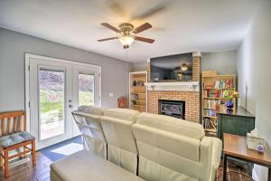 a living room with a couch and a ceiling fan at Lakefront Kingsport Home with Private Hot Tub! in Kingsport
