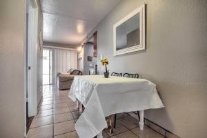 a dining room with a table with a white table cloth at Relaxing Poway Abode Near Parks and Wineries! in Poway
