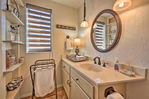 a bathroom with a sink and a mirror at Tuscan Getaway with Premier Vineyard Views! in Cottonwood