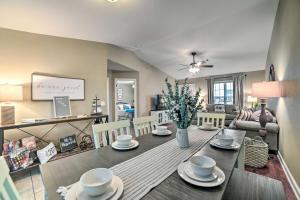 a dining room and living room with a table and chairs at Quaint Family Home Near Downtown Murray and MSU in Murray