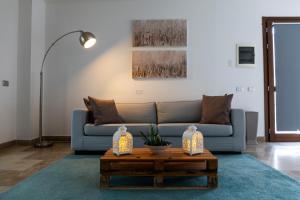 a living room with a blue couch and a coffee table at The Florence Hills Resort & Wellness in Pelago