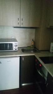 a kitchen with a microwave and a sink at Апартаментен Комплекс Сплендид - Студио Афродита, № 113 in Varna City +1 photo