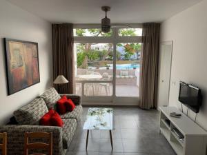 a living room with a couch and a table at Apartamento MIRI in Costa Teguise