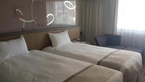 Postel nebo postele na pokoji v ubytování Kaohsiung Chateau de Chine Hotel