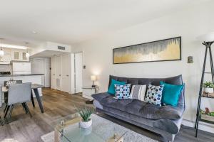 a living room with a couch and a table at Ground Floor Cozy Condo Seconds from the Beach with Private Terrace in South Padre Island