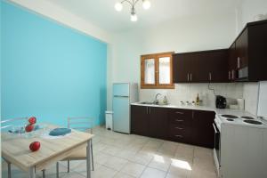 a kitchen with a table and a kitchen with a stove and refrigerator at Nikea apartment near Piraeus port and metro st I in Piraeus