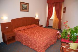 Postel nebo postele na pokoji v ubytování Hotel Garden