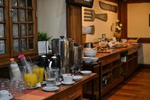 a kitchen with a counter filled with food and drinks at Hotel Centro Naval in Buenos Aires