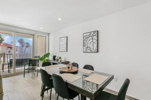 a dining room with a table and chairs at Fully Renovated Condo Steps from the Beach with Ocean View Balcony in South Padre Island
