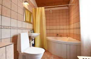 uma casa de banho com um WC, uma banheira e um lavatório. em Cozy cottage in Arjang near the lake and untouched nature em Arjäng