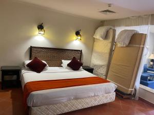 a bedroom with a bed and two bunk beds at Patio suite, Porto marina in El Alamein +15 photos
