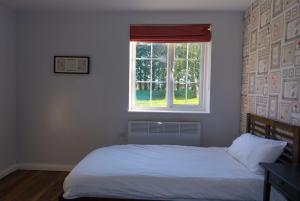 a bedroom with a white bed and a window at The Oak Baginton in Coventry