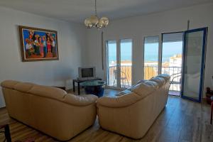 a living room with two leather couches and a television at SeetheSea in Nazaré