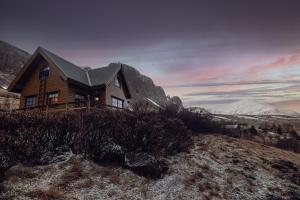 a house on the side of a mountain at Vindheimar Cottage - Great View - Hot Tub in Skeljabrekka