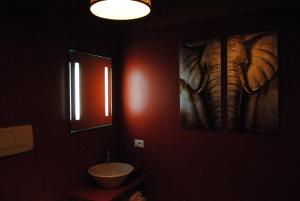 a bathroom with a painting of an elephant on the wall at Washington Apartments al Vittoriale in Gardone Riviera