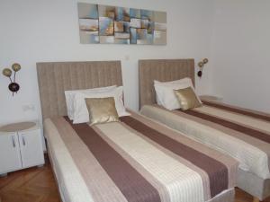Postel nebo postele na pokoji v ubytování Apartments Miki 2
