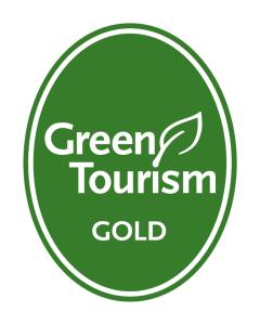 un signo de oro del torneo verde en un círculo verde en Burnside Cottage en Wick