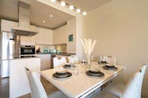 a kitchen with a white table and white chairs at Holiday Apartment Azalea La Cala in La Cala de Mijas