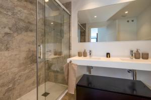 a bathroom with a glass shower and a sink at Holiday Apartment Navigolf La Cala in La Cala de Mijas +13 photos