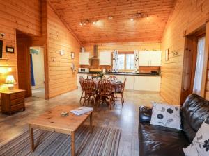 a living room with a couch and a table at Chloe's Lodge in Pickering +16 photos