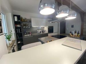 a kitchen with a white counter and some lights at Bochum ich komm aus Dir! in Bochum