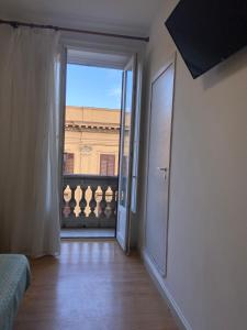 an open door to a room with a view at 38 Aira Hotels in Palermo