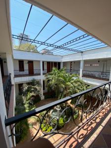 a balcony with a view of a building with trees at Hotel Casa Bethel in Santa Marta