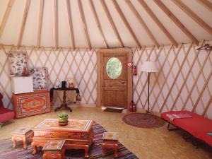 a room with a yurt with a table and a door at Eco-hôtel et Yourtes du Mercantour in Guillaumes