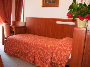 Postel nebo postele na pokoji v ubytování Hotel Garden