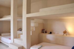 a room with two bunk beds and a staircase at La Pandilla Ibiza in Sant Francesc de s'Estany