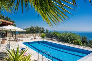 a swimming pool with a view of the ocean at Villa Theaya in Nisakion
