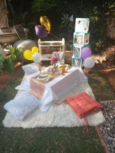 uma mesa com uma toalha de mesa branca e balões em Accommodation@42 Capital em Pretoria