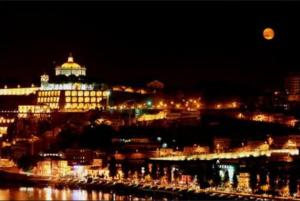 a view of a large building at night at Portugal Beach Point in Vila Nova de Gaia