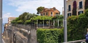 a house on a retaining wall with plants at Grimaldi Guest Apartment in Sorrento
