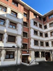 an apartment building with a lot of windows at Apartment for 4 in Lejona Casa Natalia NO ELEVATOR in Leioa