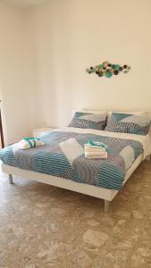 a bed in a room with towels on it at Grimaldi Guest Apartment in Sorrento