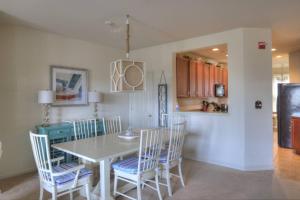 a kitchen and dining room with a table and chairs at 128E October Glory Ave, Ocean View in Ocean View
