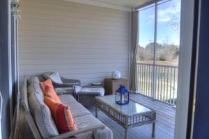 a screened in porch with a couch and a table at 128E October Glory Ave, Ocean View in Ocean View +42 photos
