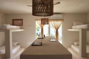 a long table in a room with two windows at La Pandilla Ibiza in Sant Francesc de s'Estany +136 photos