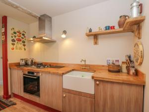 a kitchen with a sink and a stove at The Old Stables in Usk